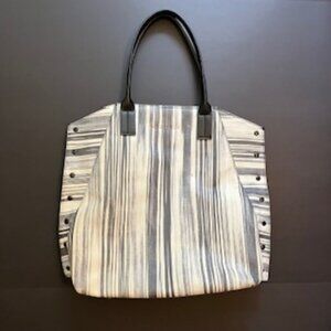 Trina Turk tote light blacks and faded grays on white.